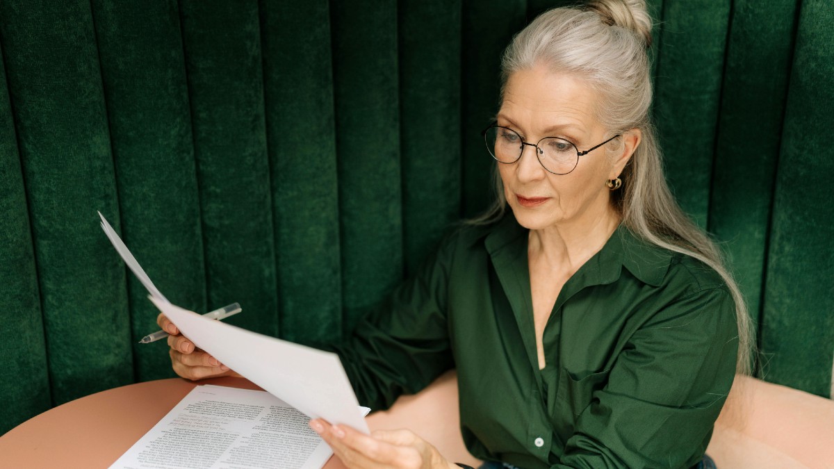 adult-woman-reading-paper.jpg